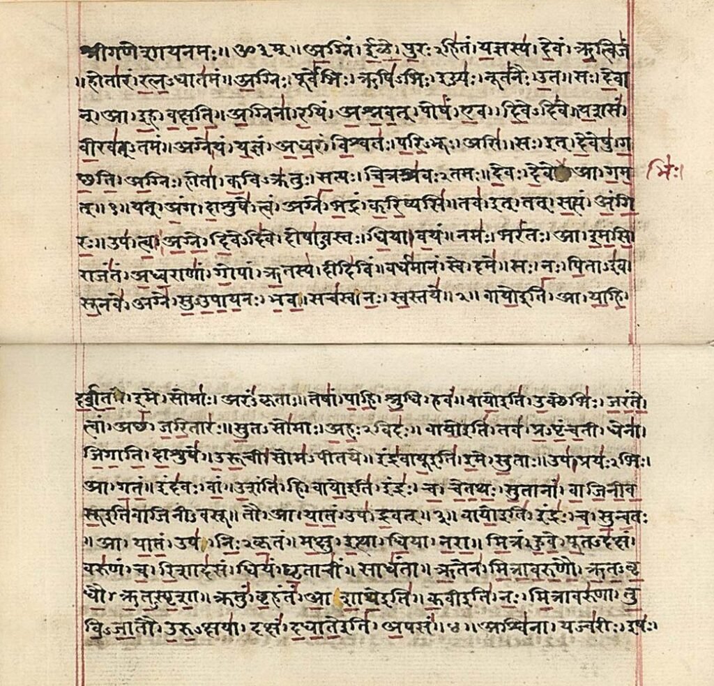 Rigveda manuscript in Sanskrit Devanagari script, with black lettering and red annotations.